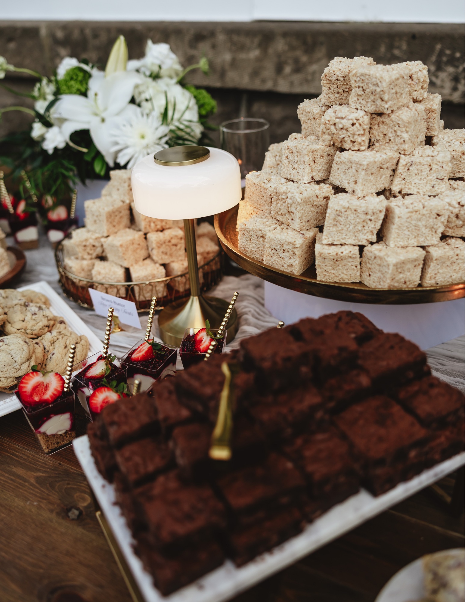 Dessert bar at the Siddoway and Vanarsdal wedding with rice crispy cubes, brownies, and cheesecake cups