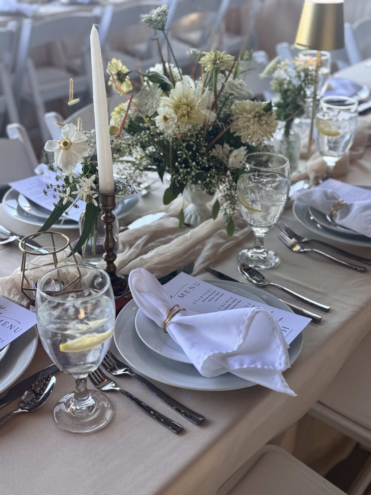 Table set with glassware, linens, and candles