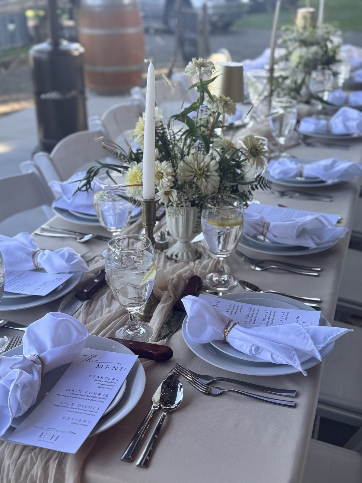 Table set with glassware, candles, and florals